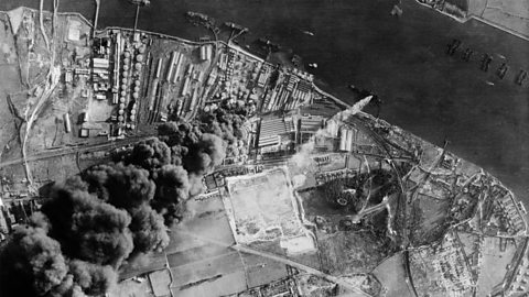 An aerial view of buildings along the Thames after being bombed