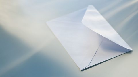 A open white envelope with light shining from it