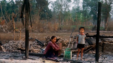 A Vietnamese woman and child among ruins