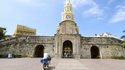 Antonio Salinas L/Getty Bicycling through the Clock Tower in the walled city of Cartagena (Credit: Antonio Salinas L/Getty)