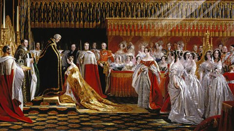 The Queen is shown kneeling in Westminster Abbey on her Coronation Day.