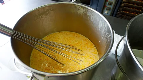 Kate Springer Whisking the cream and egg filling (Credit: Kate Springer)