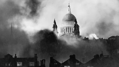 Imperial War Museum St Paul's Cathedral stands out from flames and smoke during the great fire raid in London (Credit: Imperial War Museum)