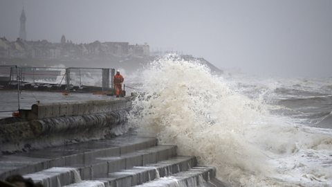 High waves reach a sea front in bad weather