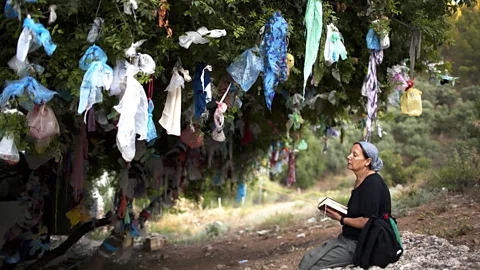 Menahem Kahana/Getty A Jewish woman reads a prayer just outside of Tzfat, (Credit: Menahem Kahana/Getty)