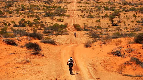 Ezra Shaw/Getty Biking through the Australian desert (Credit: Ezra Shaw/Getty)