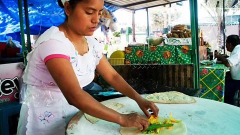 Liba Taylor/Alamy Preparing tortillas filled with calabaza flowers (Credit: Liba Taylor/Alamy)