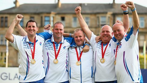 Men's singles lawn bowls gold medal-winner Darren Burnett (centre) celebrates his win with the men's fours gold medal-winning team, comprising David Peacock, Neil Speirs, Paul Foster and Alex Marshall