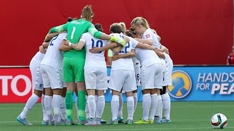 The England women's football team huddles prior to kick-off