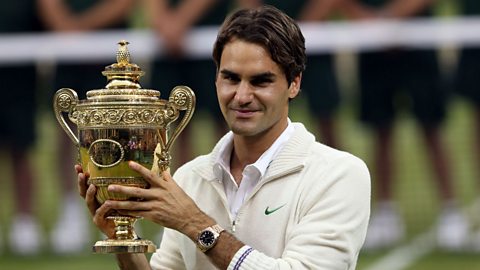 Roger Federer holding the Wimbledon trophy, in a competition that he has won a record-breaking eight times