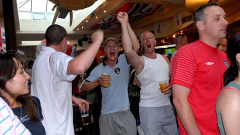 Janine Wiedel Photolibrary/Alamy Stock Photo English football fans watch a World Cup match, lagers in hand; the drink is closely associated with British identity (Credit: Janine Wiedel Photolibrary/Alamy Stock Photo)