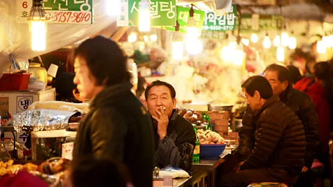 Ed Jones/Getty Enjoying one of the many quirky eateries in Seoul (Credit: Ed Jones/Getty)