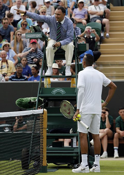 A tennis player argues with the chair umpire at Wimbledon