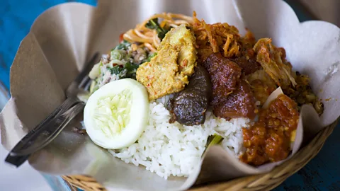 dbimages/Alamy Babi guling is best served with vegetables, rice and spices (Credit: dbimages/Alamy)