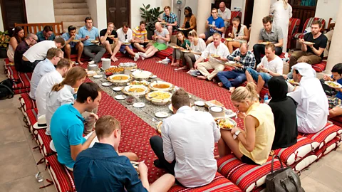 SMCCU Tourists circle around a traditional Emirati buffet (Credit: SMCCU)