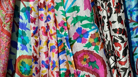 Kasia Nowak/Alamy Silks hang in stalls at local markets (Credit: Kasia Nowak/Alamy)