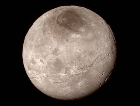 An image of Pluto with an enormous canyon that can be seen on the top-right of the image