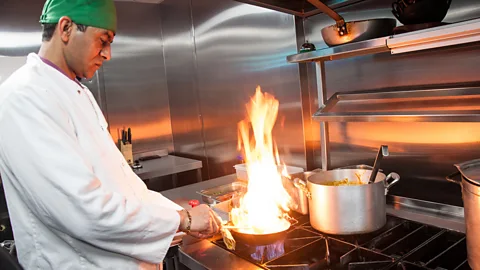 Amanda Ruggeri Cooking a balti the "proper" way – in a stainless steel balti bowl over an open flame – in the kitchen of Adil (Credit: Amanda Ruggeri)