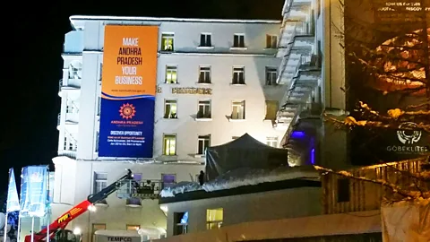 Lucy Marcus A banner hung at the Belvedere hotel as workers finalise preparations for the WEF annual meeting. Other adverts adorn parts of the exterior of the hotel. (Credit: Lucy Marcus)