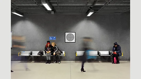 Thierry Bal People pass by one of Mark Wallinger's Labyrinth prints on the London Underground in 2013 (Credit: Thierry Bal)