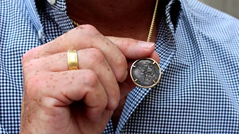Chris Baraniuk Steve St Amour wears a coin from another shipwreck around his neck (Credit: Chris Baraniuk)