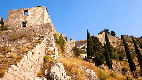 ihar leichonak/Alamy Kotor's ramparts seem to switchback up a steep mountainside (Credit: ihar leichonak/Alamy)
