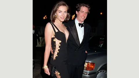 Getty Images Elizabeth Hurley wore this Versace dress with gold safety pins to the premiere of Four Weddings and a Funeral in 1994 – and caused a sensation (Credit: Getty Images)