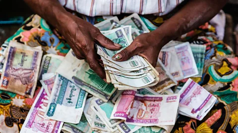 Alamy A woman counting notes (Credit: Alamy)