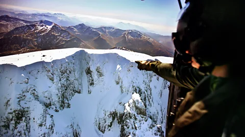 Getty Images A helicopter flies over Ben Nevis, whose true height remained elusive until recently (Credit: Getty Images)