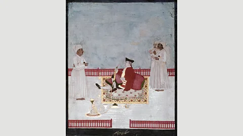 Heritage Image Partnership Ltd/Alamy A Company official smokes a water-pipe in Mughal, India in 1760 (Credit: Heritage Image Partnership Ltd/Alamy)