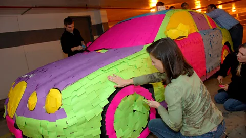 Scott Ableman/Flickr/CC BY-NC-ND 2.0 Employees cover a colleague's Jaguar in sticky post-it notes. (Credit:Scott Ableman/Flickr/CC BY-NC-ND 2.0)