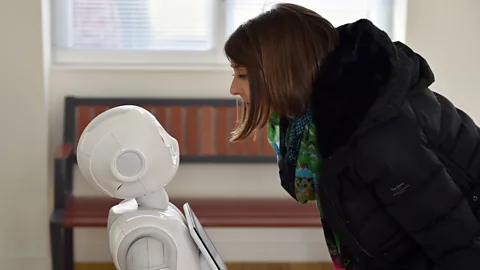 Loic Venance /AFP/Getty Images Do we really trust robots more than humans when it comes to our money? (Credit: Loic Venance /AFP/Getty Images)