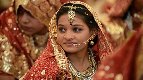 Sam Panthaky/AFP/Getty A bride in Ahmedabad, India; each wedding in India results in the purchase of an average 30 to 40 grams of gold (Credit: Sam Panthaky/AFP/Getty)