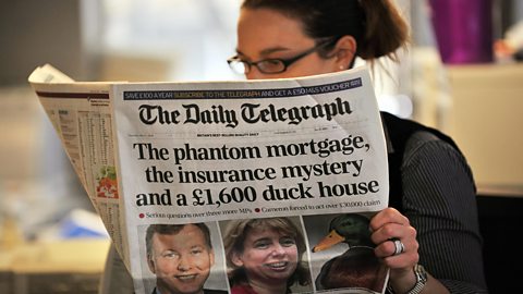 Photograph of a woman reading the Daily Telegraph