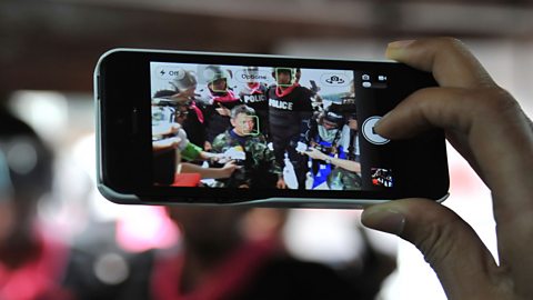 Photograph of citizen journalist filming on a smart phone