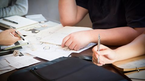 Photograph of individuals writing and researching