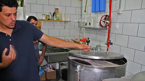Dana Shemesh Gutman mixes milled grains with hops, water and yeast to create his beer (Credit: Dana Shemesh)