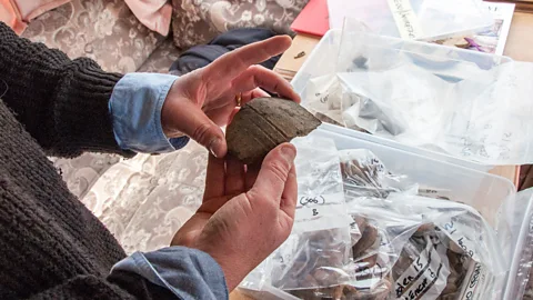 Amanda Ruggeri Gossip examines one of the pottery shards found in the Boden excavation (Credit: Amanda Ruggeri)