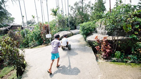 Tanveer Badal Children play on Mawlynnong’s immaculate streets, which are maintained daily by children and dedicated town gardeners (Credit: Tanveer Badal)