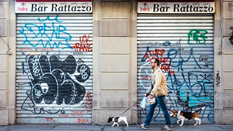Lance Henderstein A man and his dogs walk past Bar Rattazzo early in the morning (Credit: Lance Henderstein)