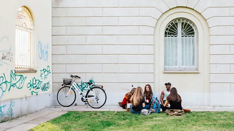 Lance Henderstein Students play cards and chat in a corner of Parco delle Basiliche (Credit: Lance Henderstein)