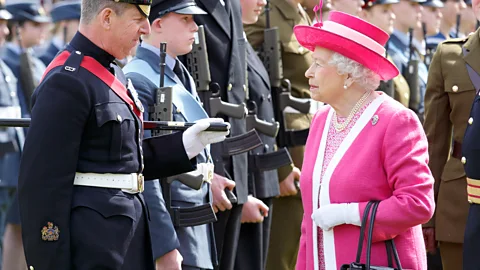 Getty Images The head-to-toe, colour-blocked daywear and matching hats that the monarch favours for her public engagements have become her personal brand (Credit: Getty Images)