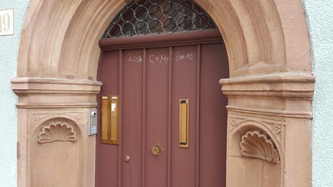 Chalk markings on a wooden door