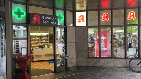 Apotheke storefront with illuminated signs