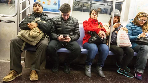 Alamy The solitary and unsociable way we behave on mass transit could be detrimental. (Credit: Alamy)