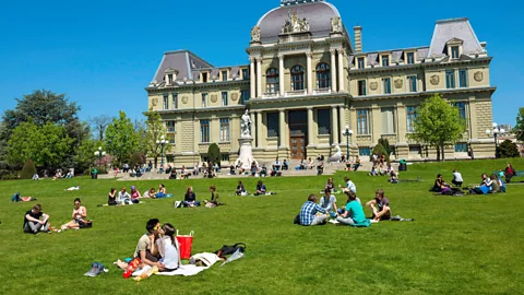 Hemis/Alamy People gather on a lawn in the Swiss university town of Lausanne (Credit: Hemis/Alamy)