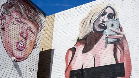 Rex Features A mural of Kim Kardashian's infamous naked selfie next to a mural of Donald Trump, reportedly the work of the street artist 'lushsux' (Credit: Rex Features)
