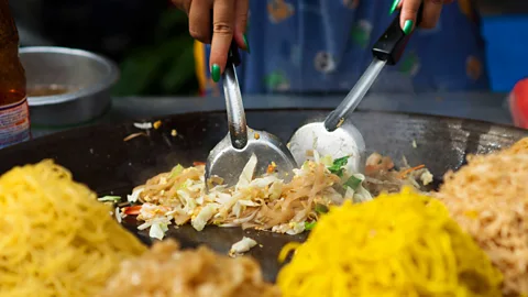 Karolina Webb/Alamy Pad thai is a staple of Bangkok's street food scene - but will it fall victim to the "cleaning up" of Bangkok's streets? (Credit: Karolina Webb/Alamy)