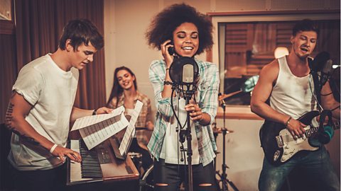 Multiracial music band performing in a recording studio