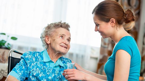 Senior woman with her caregiver at home